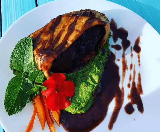 Beef Wellington with a herb purée and a dark sauce